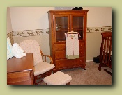 Diaper caddy hanging from armoire.